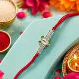 Silver Rakhi with Green Stone & Red Thread